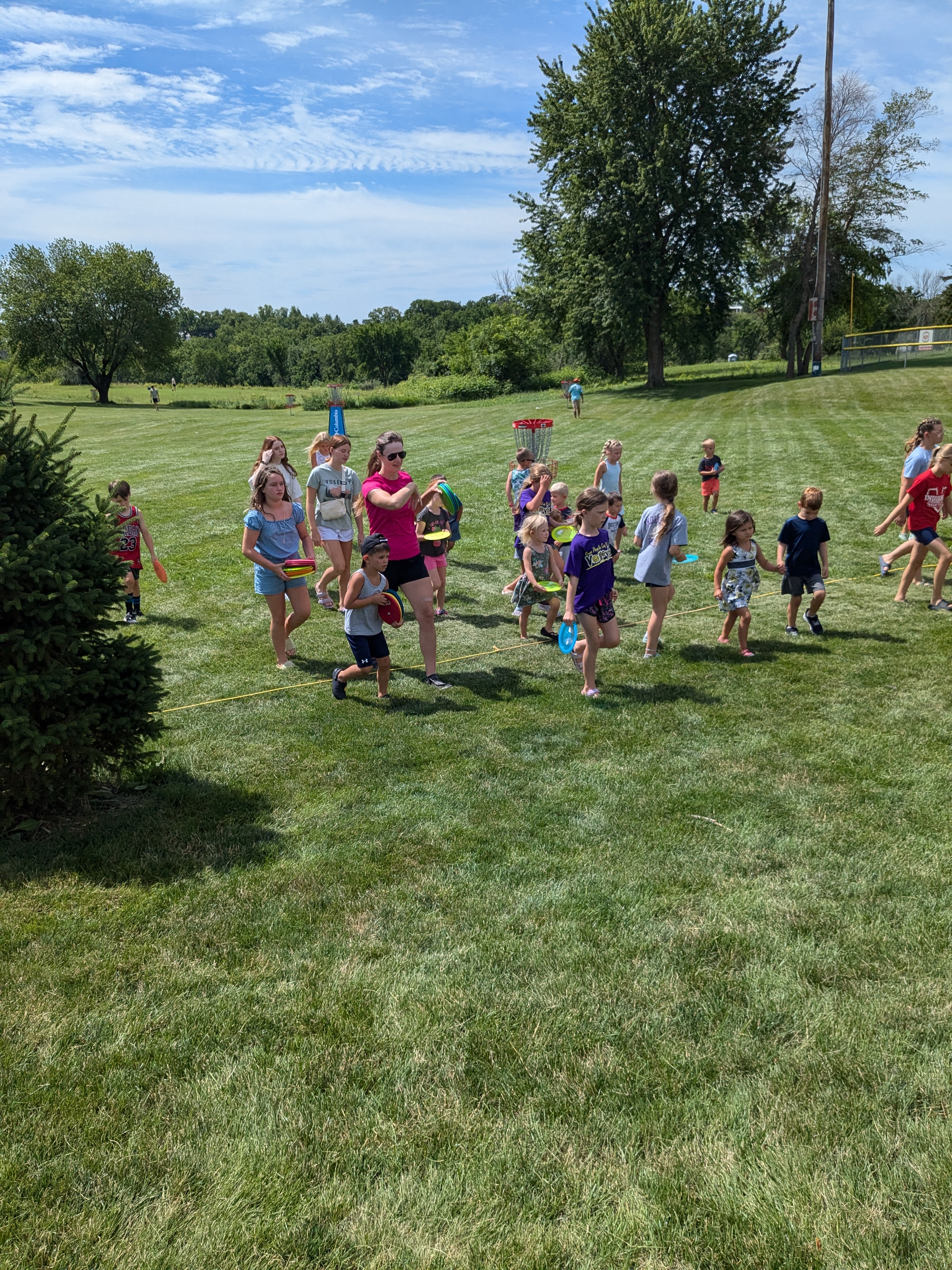 Kids playing disc golf